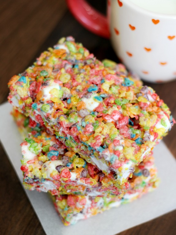 A chewy and spongy, Fruity Pebbles treats recipe made with cereal and marshmallows! Bright and colorful, perfect as an after school snack or for bake sales. 