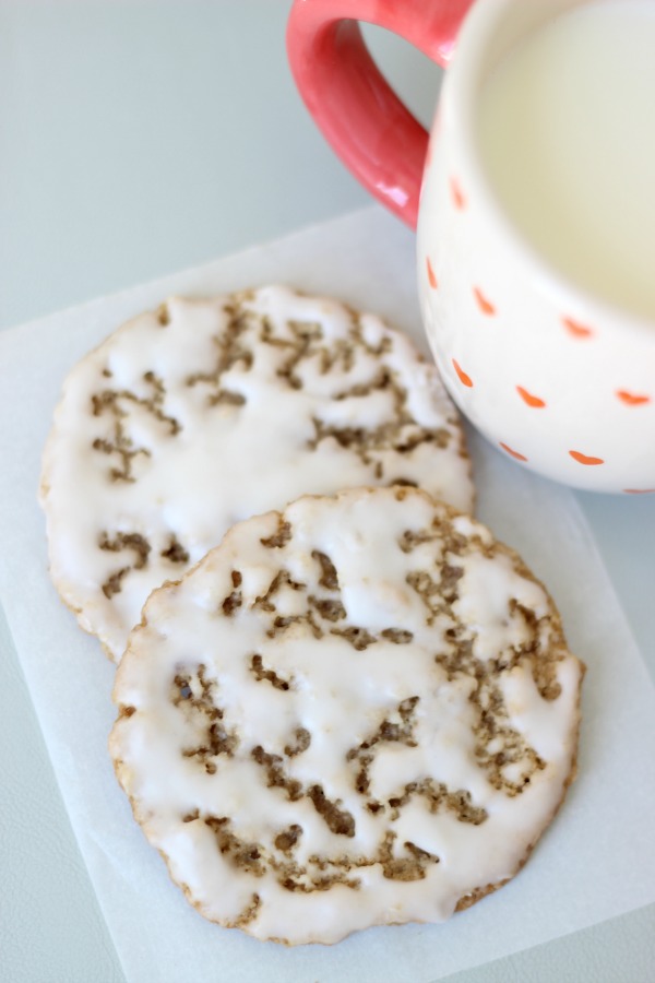 two cookies with a glass of milk on napkin