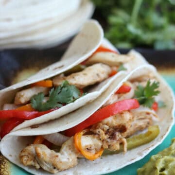 two fajitas on plate with guacamole