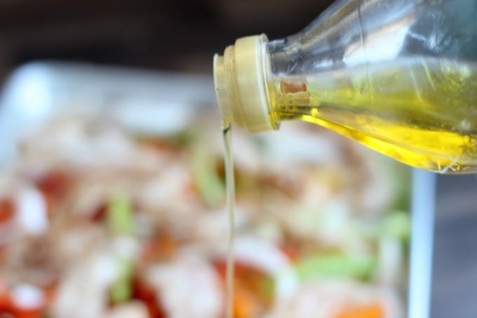 drizzle of olive oil coming out of bottle