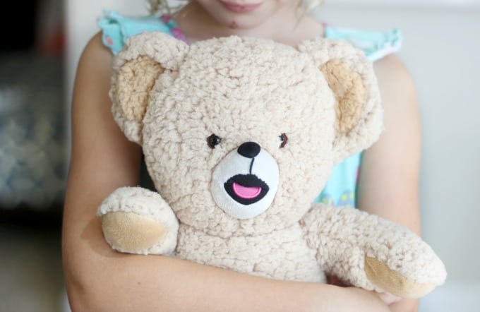 child holding stuffed animal