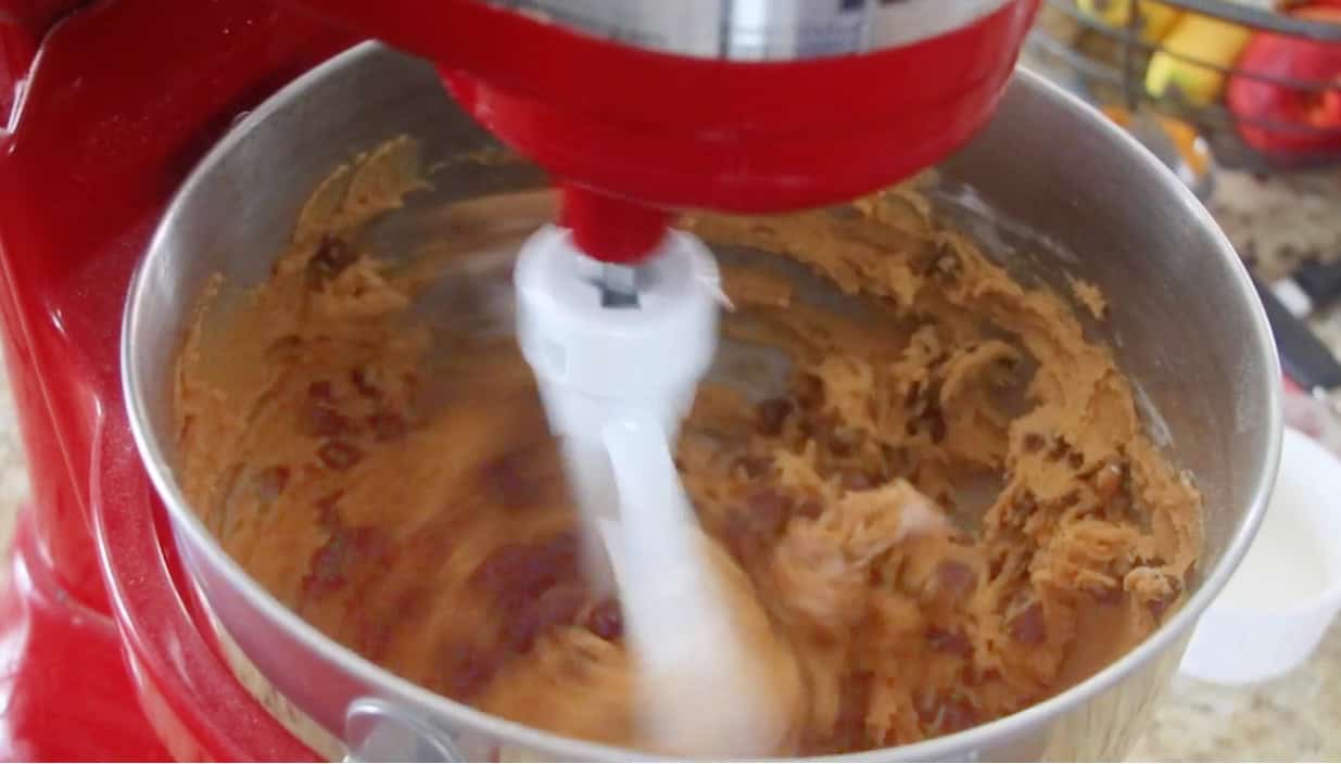 Stand mixer mixing pumpkin cookie dough.