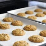 Two baking sheets of pumpkin chocolate chip cookies.