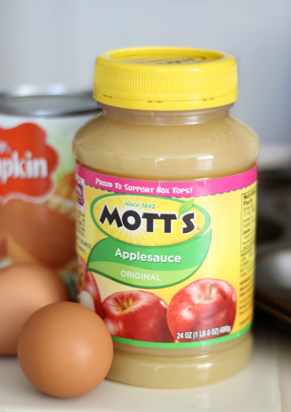 bottle of applesauce and two brown eggs