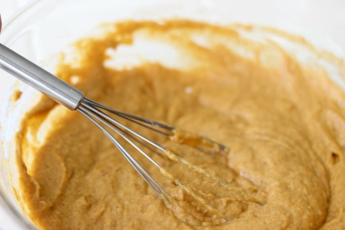 the best pumpkin bread batter in a bowl with a whisk