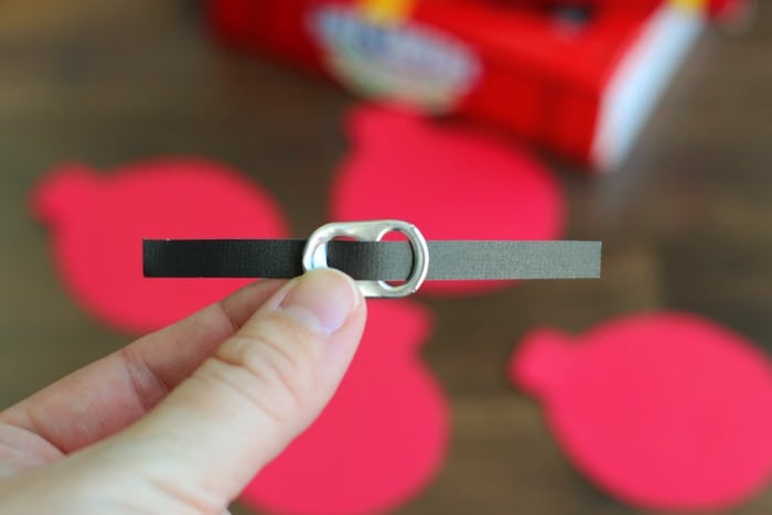 These quick and easy Santa Suit gift tags, made out of cardstock and soda can tabs, are the perfect addition to any gift this holiday season!