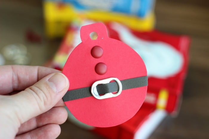 These quick and easy Santa Suit gift tags, made out of cardstock and soda can tabs, are the perfect addition to any gift this holiday season!