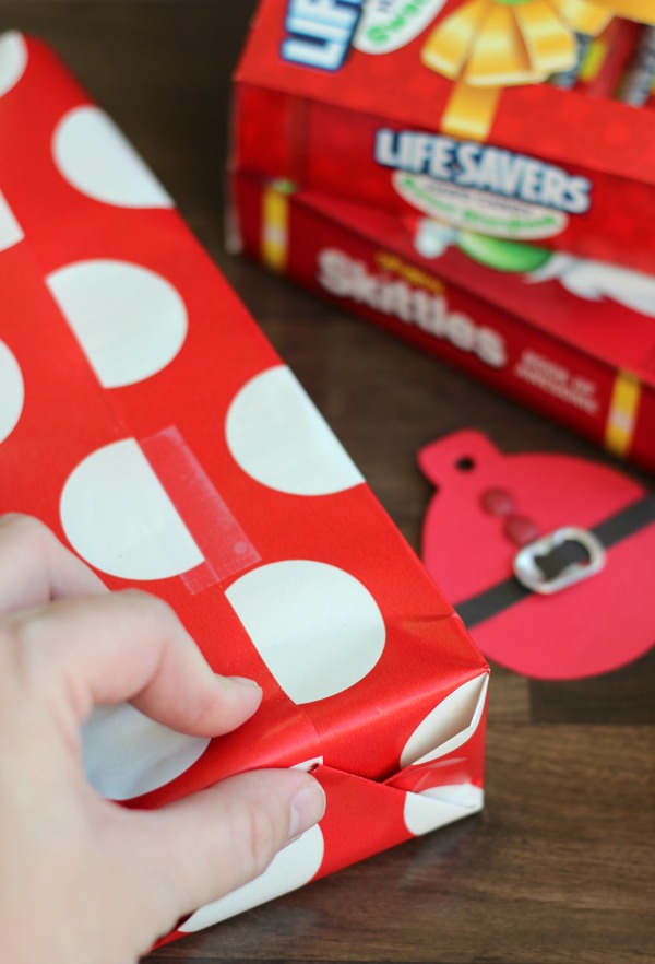 These quick and easy Santa Suit gift tags, made out of cardstock and soda can tabs, are the perfect addition to any gift this holiday season!