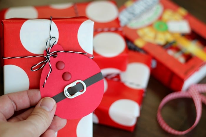 These quick and easy Santa Suit gift tags, made out of cardstock and soda can tabs, are the perfect addition to any gift this holiday season!