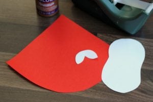 copy paper cut into Santa shapes