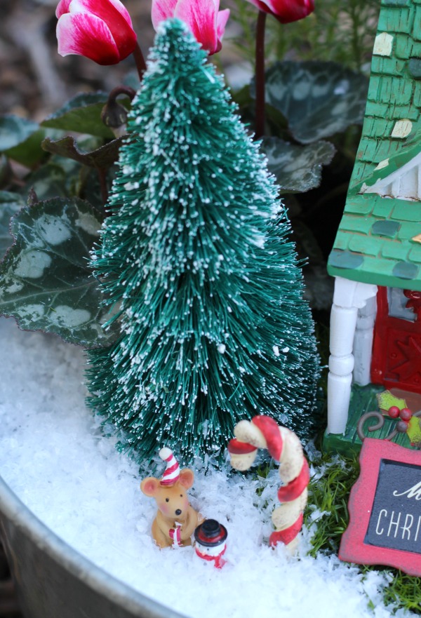 A beautiful Christmas fairy garden to brighten your porch or home this holiday season! Get the kids involved for a magical project that will last all season!
