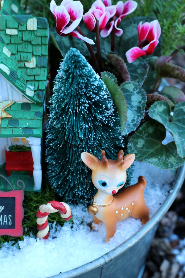 A beautiful Christmas fairy garden to brighten your porch or home this holiday season! Get the kids involved for a magical project that will last all season!