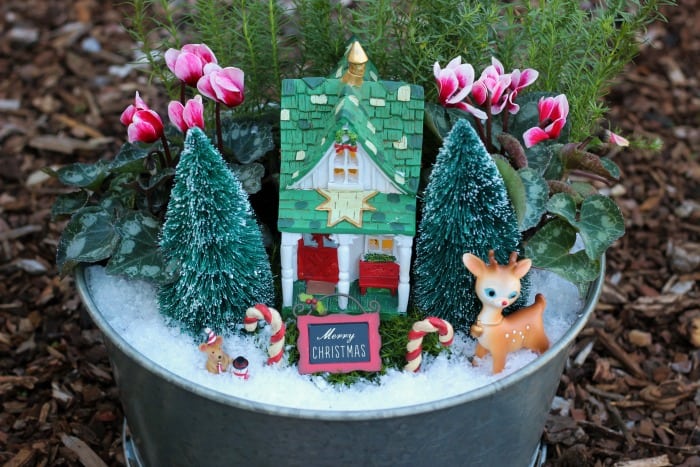 A beautiful Christmas fairy garden to brighten your porch or home this holiday season! Get the kids involved for a magical project that will last all season!