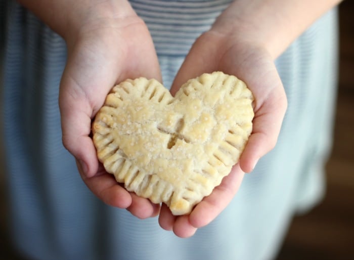 hands holding lemon hand pie