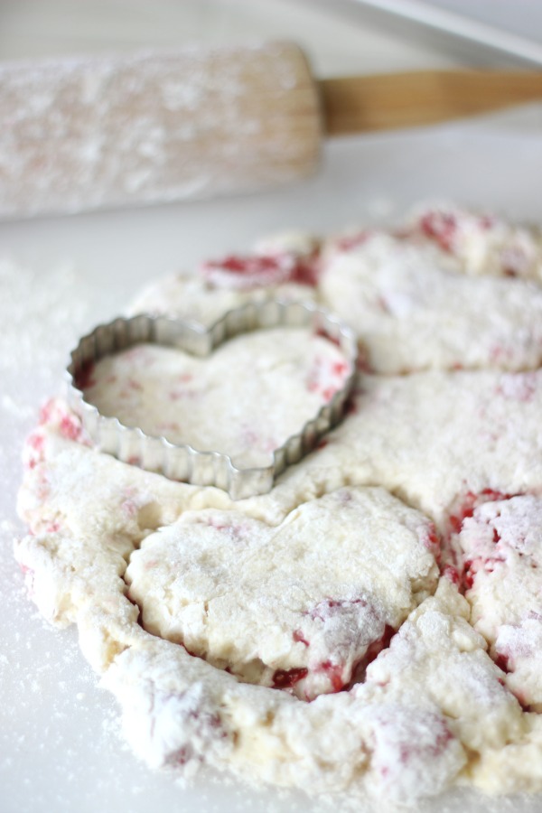 heart cookie cutter on top of rolled out scone dough