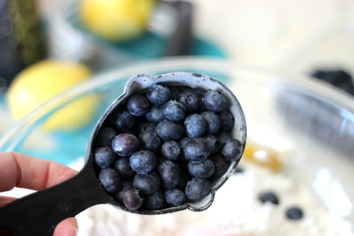 measuring cup with fresh blueberries