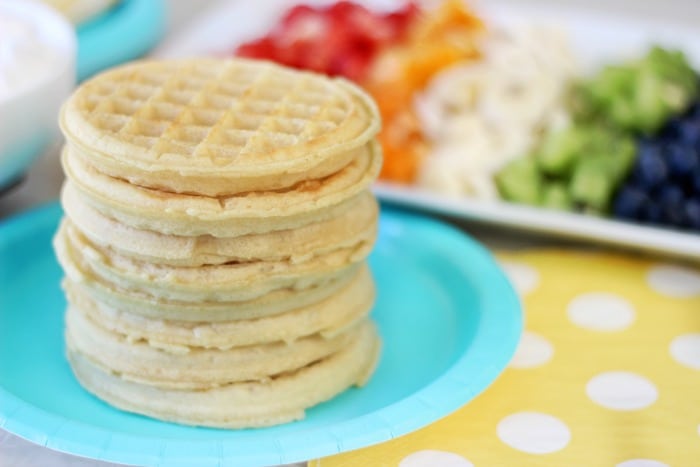 A delicious fruit waffle bar that is as colorful as the rainbow! Fresh fruit, cream, and waffles combine for the perfect St. Patrick's Day breakfast (or dinner!) that the whole family will love. 