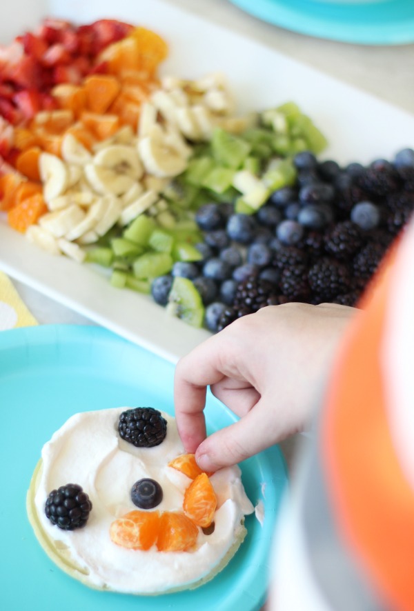 A delicious fruit waffle bar that is as colorful as the rainbow! Fresh fruit, cream, and waffles combine for the perfect St. Patrick's Day breakfast (or dinner!) that the whole family will love. 