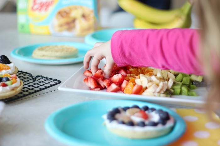 A delicious fruit waffle bar that is as colorful as the rainbow! Fresh fruit, cream, and waffles combine for the perfect St. Patrick's Day breakfast (or dinner!) that the whole family will love. 