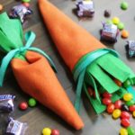 two carrot candy pouches filled with jelly beans