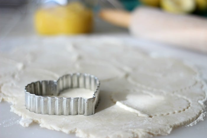 rolled out pie crust cookies cut out with cookie cutter