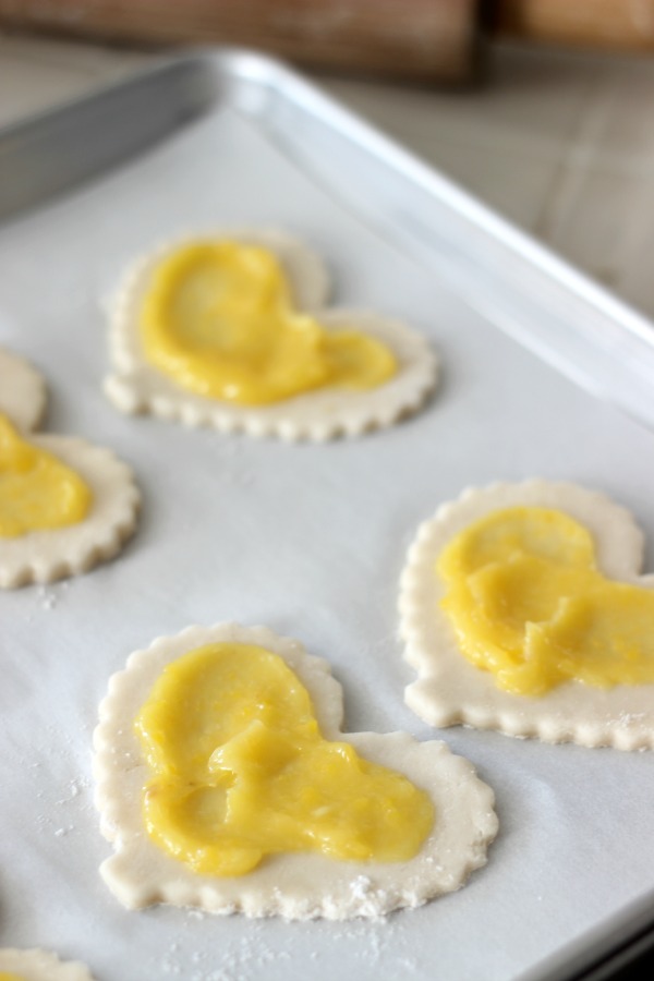 lemon curd spread on pie crust cut out