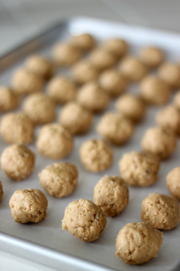 peanut butter balls on baking sheet