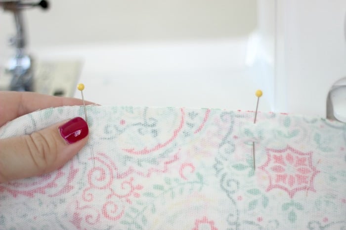 Add a pop of color to your table this spring with a DIY table runner! A quick and easy beginning sewing project. Use coordinating fabrics for a reversible runner!