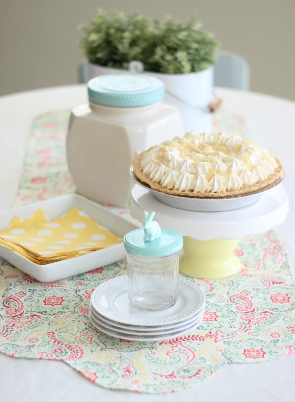 Add a pop of color to your table this spring with a DIY table runner! A quick and easy beginning sewing project. Use coordinating fabrics for a reversible runner!