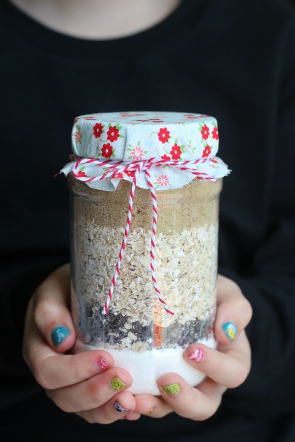 girl holding jar of scripture cookie ingredients