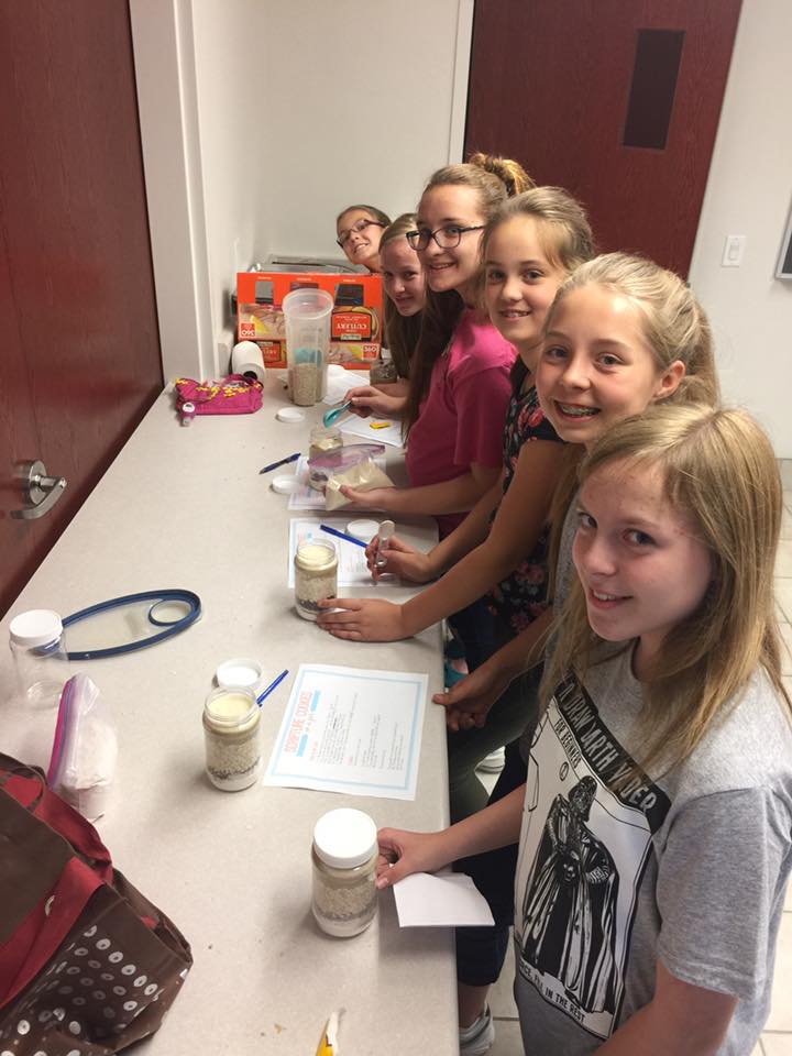 teenagers preparing jars with ingredients