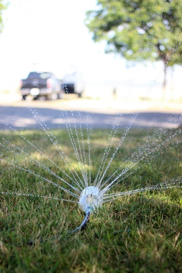 soda bottle sprinkler on grass