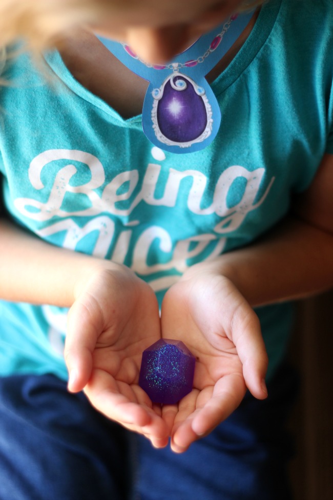 child holding gem soap in hands