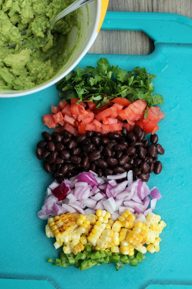 Bold, colorful and flavorful. This black bean and corn guacamole recipe hits the spot any day of the week. Perfect to serve with chips, or to add to a southwest rice bowl.