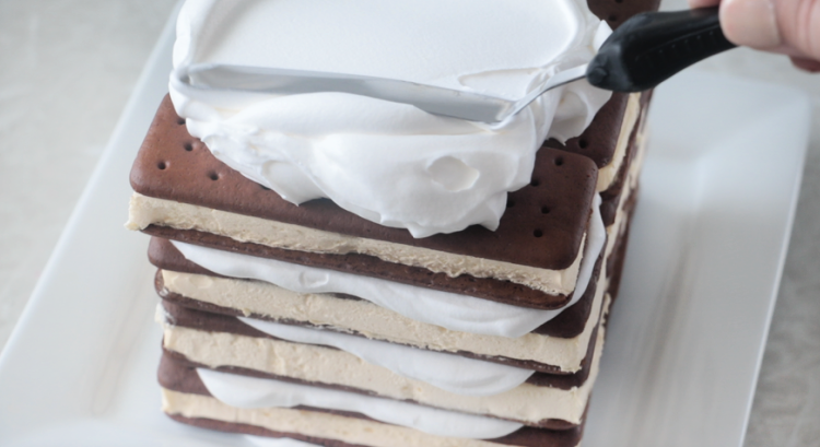 stack of ice cream sandwiches frosted with whipped cream