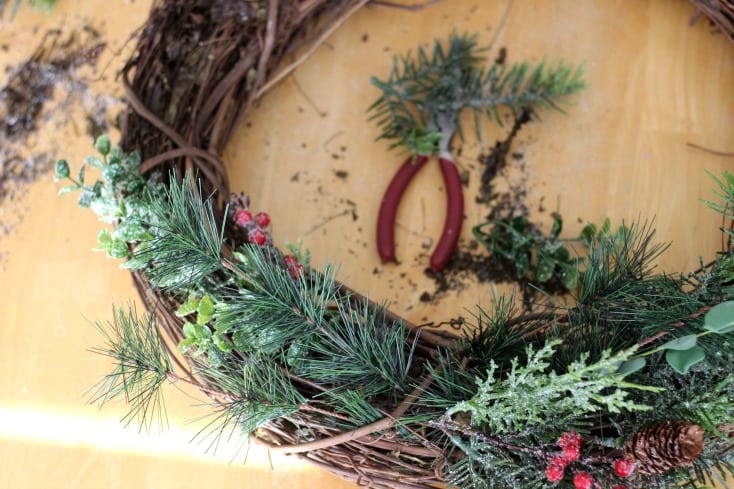 Make a gorgeous winter berry wreath for your front door with a few supplies from your local craft store. An easy to follow wreath tutorial and inexpensive way to add a touch of color and to your home this holiday season! 