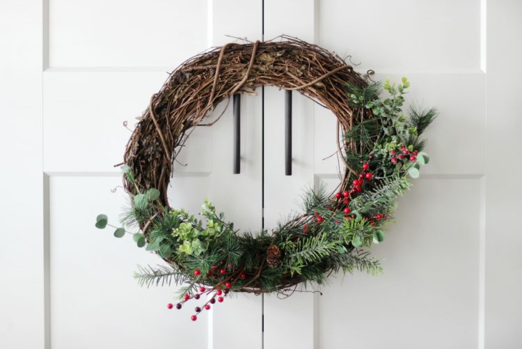 Make a gorgeous winter berry wreath for your front door with a few supplies from your local craft store. An easy to follow wreath tutorial and inexpensive way to add a touch of color and to your home this holiday season! 