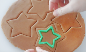 star cookie cutter cutting out gingerbread cookies