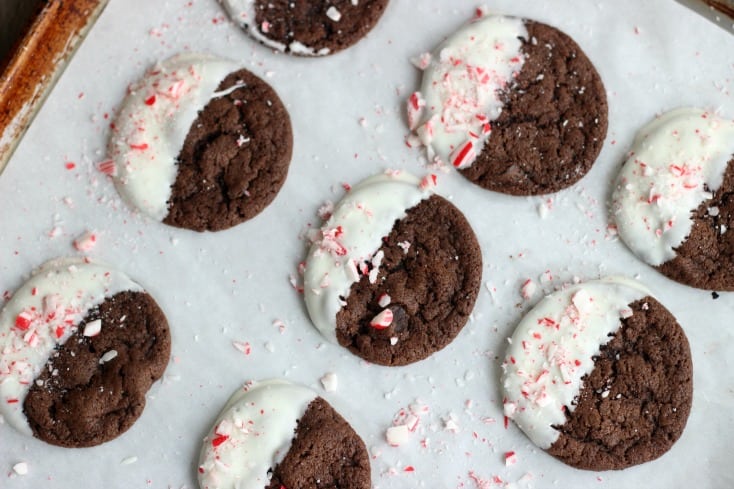 peppermint cookies dipped in white chocolate on baking sheet