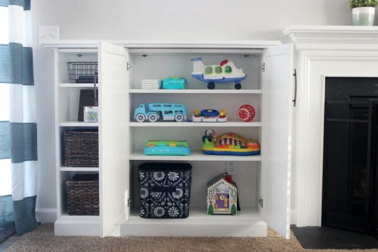 Organize your living room and make built ins for books, toys, and electronics with IKEA bookcases! Add trim, doors, hardware, and a top for a custom look.