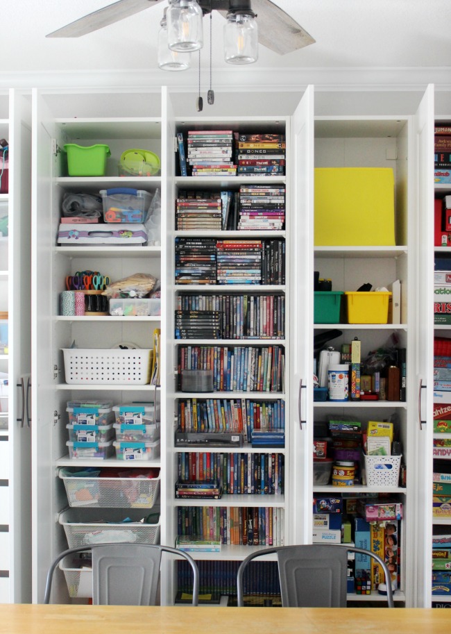 Create a wall of custom bookcases my customizing wardrobes and bookcases for a beautiful wall of IKEA built-ins. Its perfect for maximizing storage in a den, office, or bedroom. 