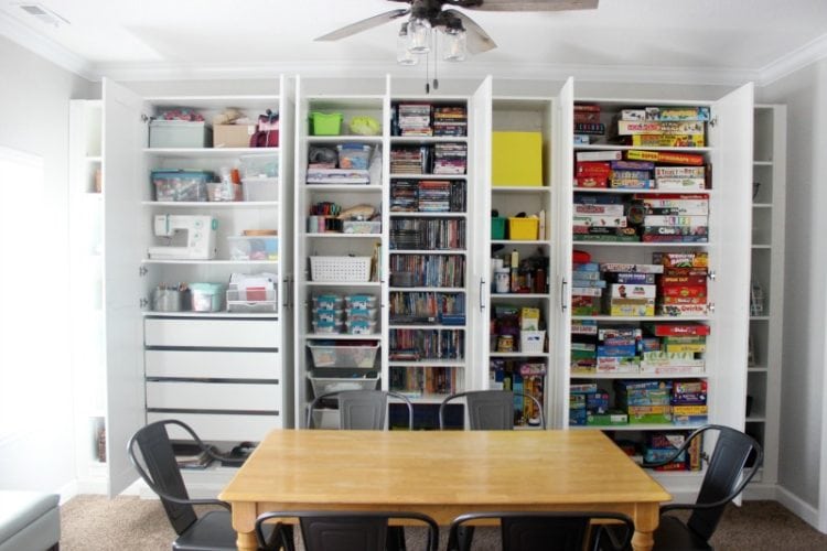 Create a wall of custom bookcases my customizing wardrobes and bookcases for a beautiful wall of IKEA built-ins. Its perfect for maximizing storage in a den, office, or bedroom. 