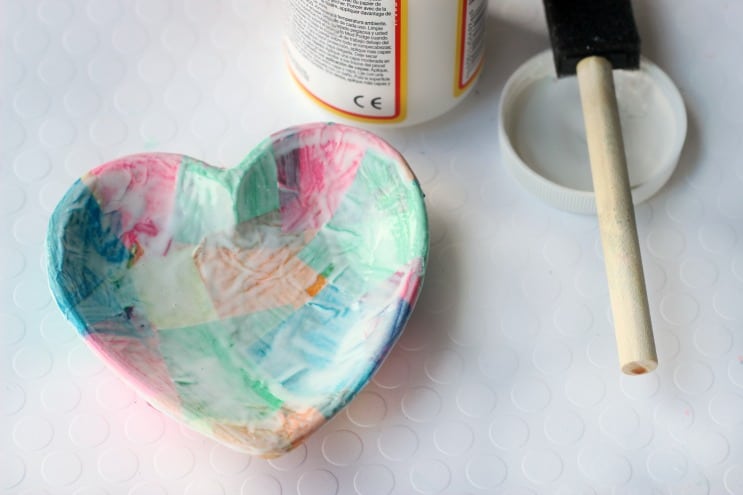 Add a bit of mod podge and tissue paper and completely transform this small bowl into a homemade jewelry dish! This technique also works on plates, jars, vases, and tile!