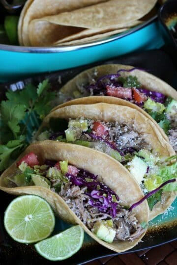 Slow cooker carnitas street tacos take less than 30 minutes to prepare. Let the pork slow cook all day for a quick and easy weeknight dinner!
