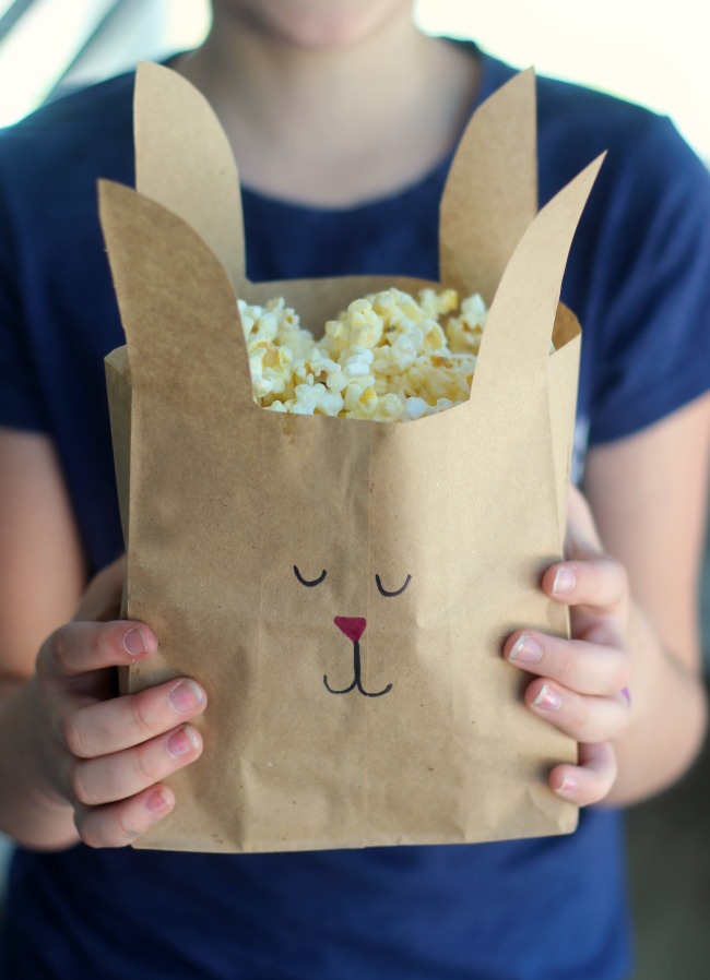Turn paper lunch sacks into bunny treat bags with just a few snips of the scissors. A quick and easy way to make your next movie night even more fun!
