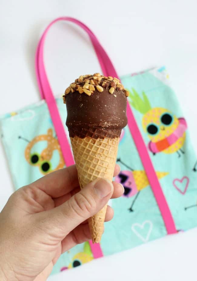 A DIY beach bag made out of a beach towel! Grab a fun and funky towel and let's get started! The perfect bag for towels, sunscreen, and treats to share with friends at the pool this summer!