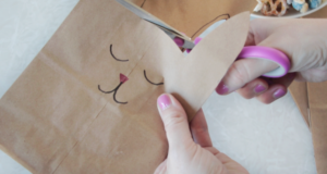 hand cutting around bunny ears with scissors