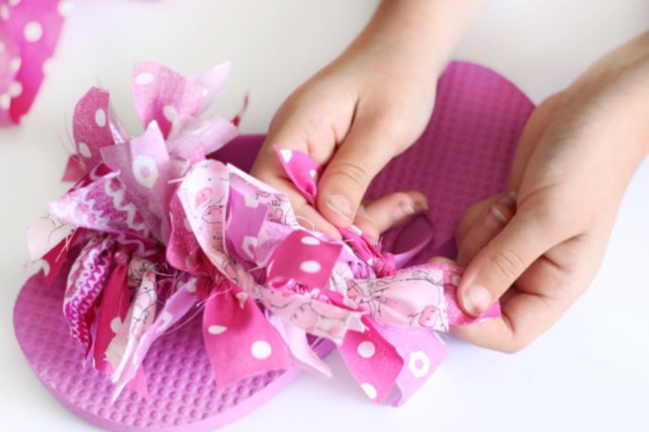 pink flip flop with fabric strips tied on