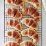 baked croissants on cooling rack