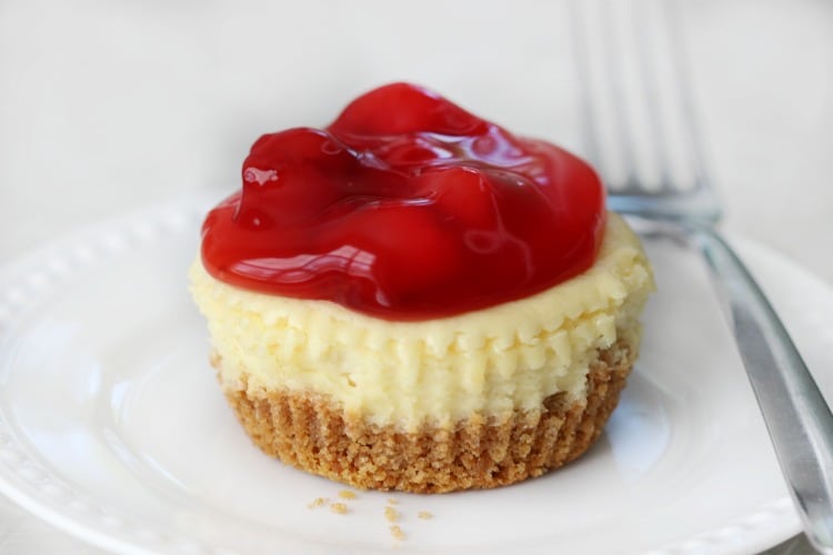 Individual sized mini cherry cheesecakes made in a jumbo muffin tin. Each batch makes 8 individual cheesecakes that are soft, delicious and ready to top with cherry pie filling.